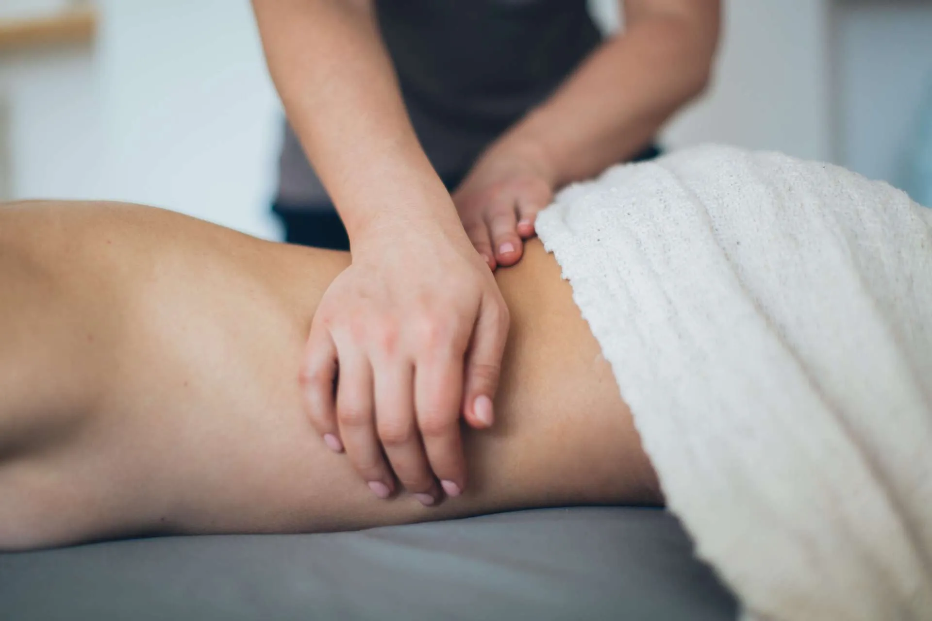 person lying in bed getting osteopathy